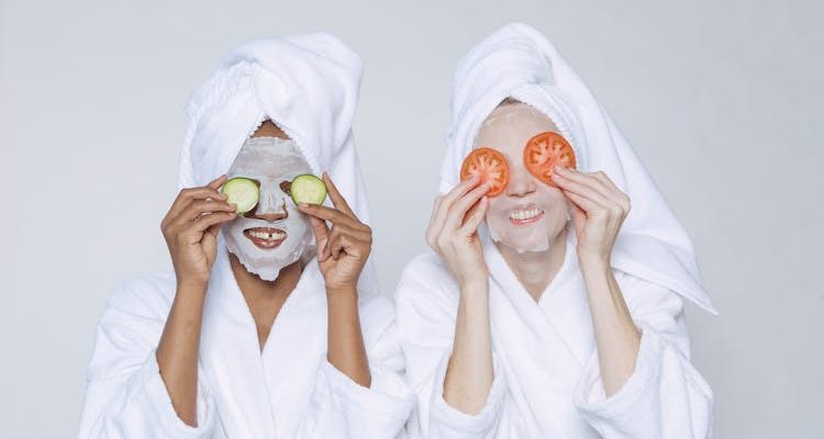 Two women applying home remedies to reduce dark circles and rejuvenate their under-eye area.