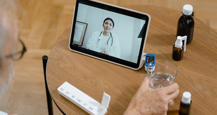 Person using a tablet for virtual medical assistance (VMeDx), connecting with a healthcare professional online.
