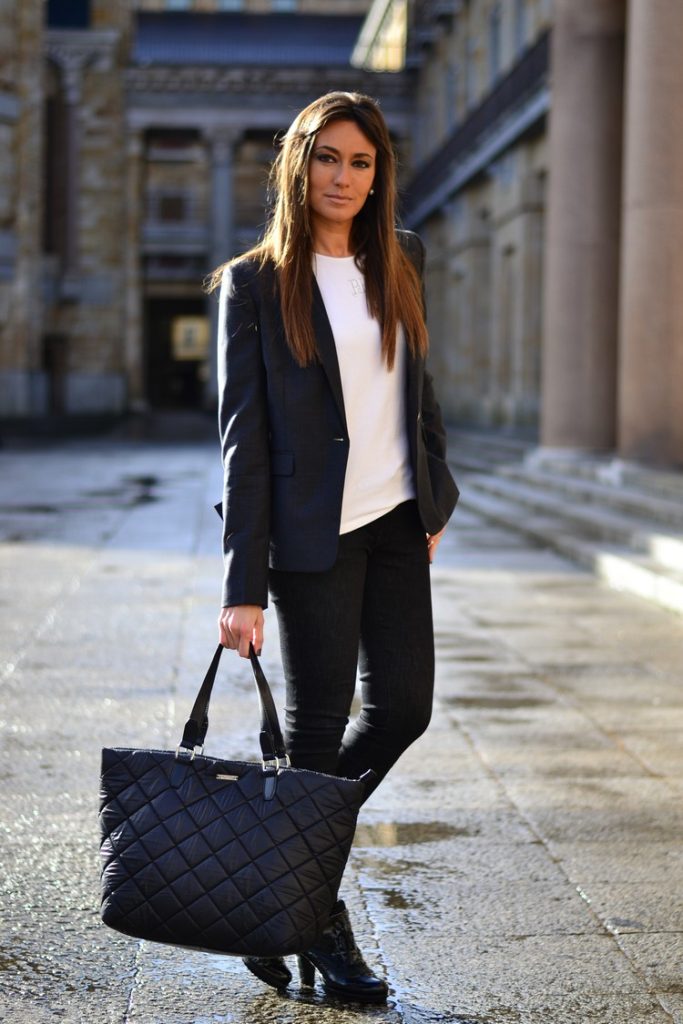 A woman exuding confidence and professionalism in a tailored blazer ensemble personifying power dressing.