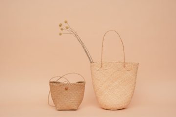 Two elegant Italian handbags displayed side by side, showcasing fine craftsmanship and stylish design.
