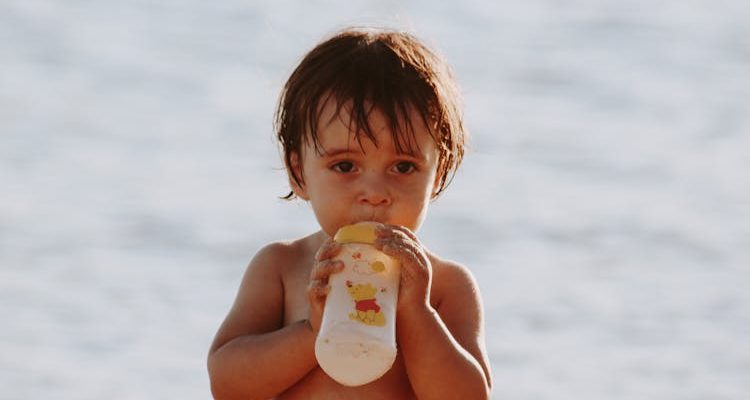 Toddler drinking immunity milk powder.