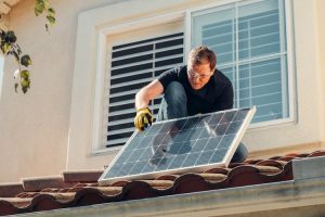 Man fixing solar panels.