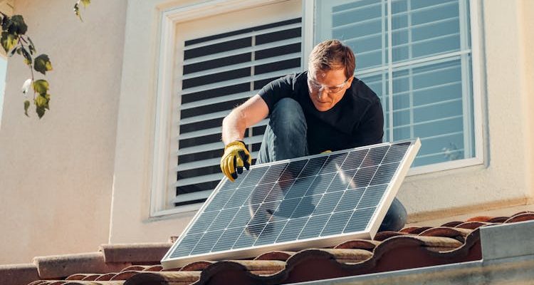 Man fixing solar panels.